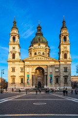 Wall Mural - Budapest, Hungary - Warm colors on St. Stephens Basilica at sunset with clear blue sky at winter time