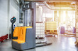 forklift electric stacker is in the workshop of factory. Electric pallet truck is in manufacturing facility. 