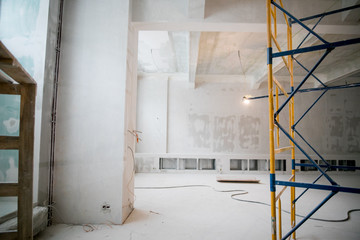 Interior construction of warehouse concrete wall and scaffolding.