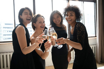 Wall Mural - Portrait happy elegant diverse girls clinking champagne glasses