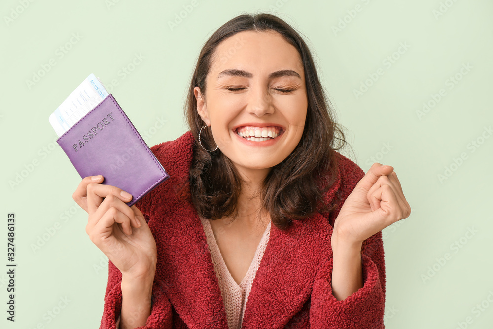Female tourist with documents on color background