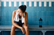 © GVS - Tired fit woman with a towel in the locker room after hard workou