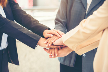 Wall Mural - Teamwork Together Concept. Group of diversity people high five on air to greeting power of tag team. Multiethnic people group working togetherness. Volunteer collaboration in Business Team success