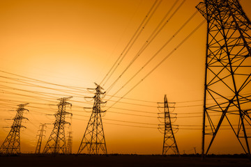 Canvas Print - High voltage power tower and beautiful nature landscape at sunset