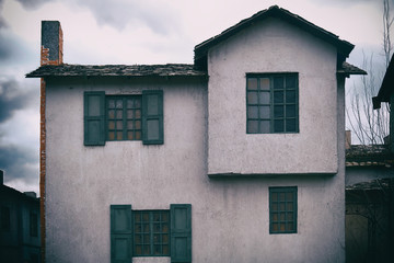 An old two story house with a chimney in the style of retro american buildings of the wild west