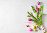 Fototapeta Tulipany - Tulips easter flat lay with pink and white flowers and eggs on white background
