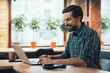 © shevchukandrey - Excited young man working on laptop stock photo