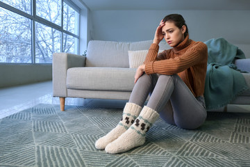 Depressed young woman at home