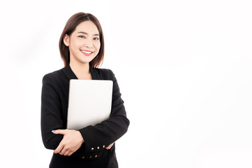 Asian businesswoman with black suit holding a laptop with big smile beaming face in white isolated background.