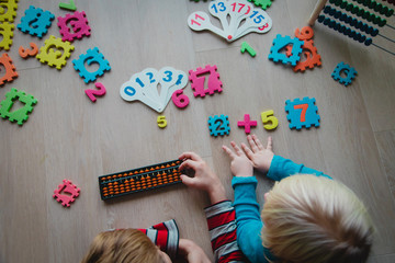 Wall Mural - kids learning numbers, boy and girl counting on abacus