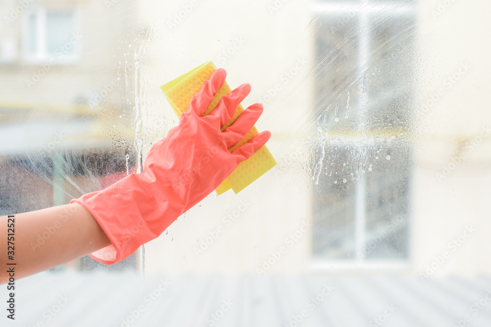 Janitor cleaning window in apartment