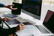 © wutzkoh - Professional development programmer cooperating meeting programming website working a software in office room.