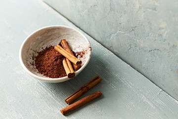 Sticker - Ceylon cinnamon sticks and cocoa powder in a bowl. Copy space