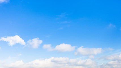 Wall Mural - panoramic view of chain of clouds in blue sky