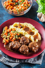 Wall Mural - Roasted meatballs in dark sauce with mashed potatoes