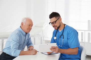 Wall Mural - Senior man visiting doctor in modern office