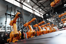 Robotic Arms Along Assembly Line In Modern Factory.