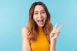 © Drobot Dean - Portrait of beautiful joyous woman smiling and gesturing peace sign
