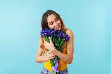 Canvas Print - Portrait of joyous young happy woman smiling while holding flowers