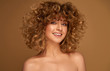 © kiuikson - Portrait of young blonde woman with curly messy hair