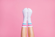 Cropped Close-up View Of Nice Vertical Feminine Legs Wearing White Casual Soft Cotton Comfortable Socks New Brandy Collection Isolated Over Pink Pastel Color Background