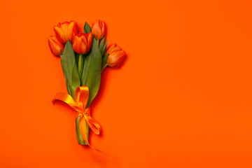 Bouquet of tulips in orange and rich red colors. Concept of Women's Day, Mother's Day, 8 March, the holiday greetings. Copy space, flat lay.