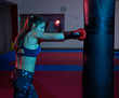 © Xalanx - Boxer girl hitting the heavy bag