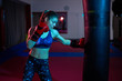 © Xalanx - Boxer girl hitting the heavy bag