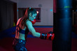 © Xalanx - Boxer girl hitting the heavy bag