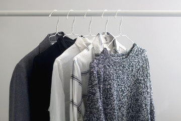 Minimal capsule wardrobe in black, white and gray tones. Selective focus.