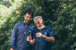 © chokniti - The old man and his son are walking in the park. A man hugs his elderly father. They are happy and smiling