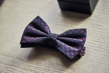 Violet bow tie on table