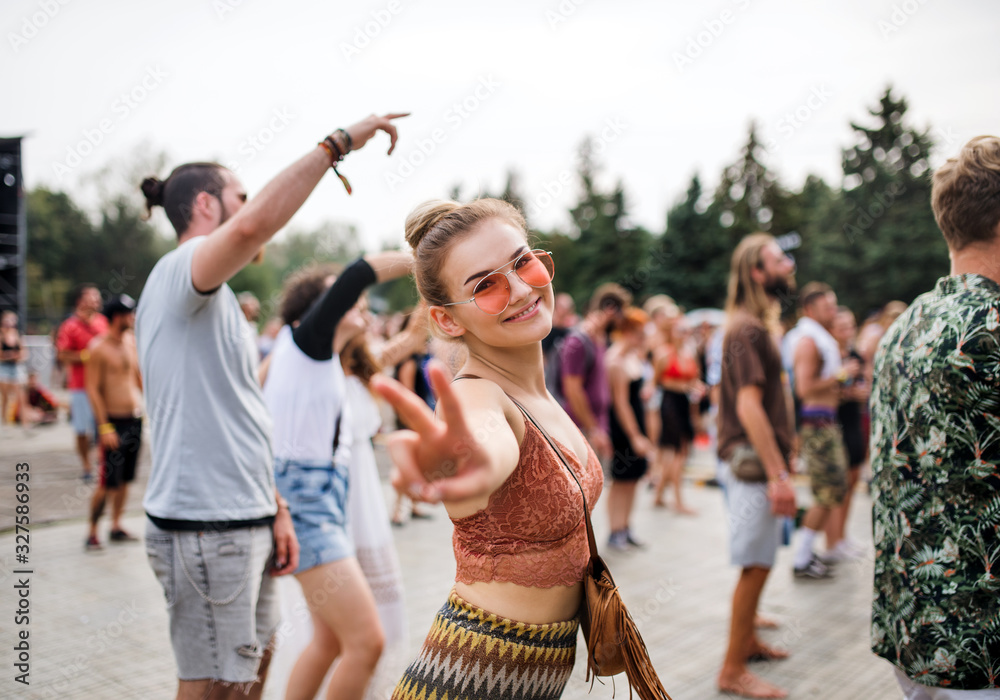 Beautiful young woman dancing at summer festival. - obrazy, fototapety, plakaty 