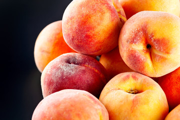 Wall Mural - Heap of ripe peaches on black background.