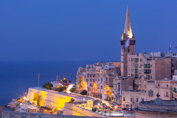 Wall Mural - View of Old town roofs and St. Paul's Anglican Pro-Cathedral at night, Valletta, Capital city of Malta