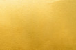 Leinwandbild Motiv Gold wall texture background. Yellow shiny gold foil paint on wall surface with light reflection
