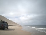 Fototapeta Sawanna - 4x4 Cars driving by the beach