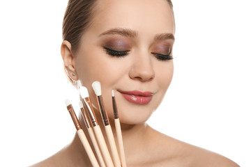 Sticker - Beautiful woman with makeup brushes on white background