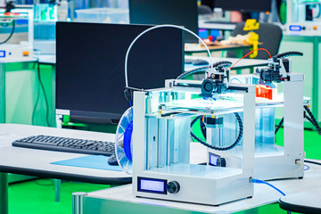 Poster - Professional 3d printer. Two 3D printers near the computer. The press of three-dimensional details for the industry. 3D printers in a design studio. Sale of equipment for three-dimensional printing