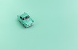 Toy Car on the road  on a mint green background . 