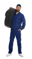 Canvas Print - Full length portrait of professional auto mechanic with tire on white background