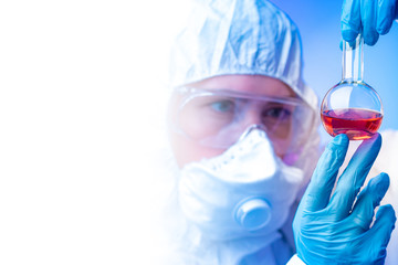 Poster - lab technician holding a test tube in his hands. concept - epidemiology. a man holds a test tube wit