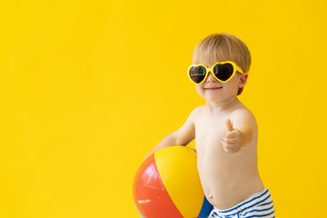 Canvas Print - Portrait of happy child holding beach ball