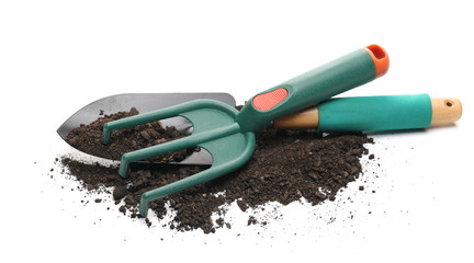 Garden shovel and rake and dirt isolated on white background