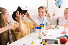 Happy School Boy Using VR Glasses At Technology Lesson