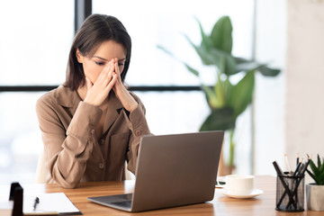 European manager sitting at desktop at workplace