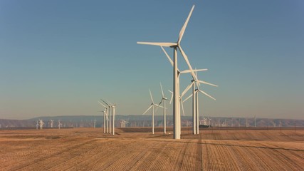 tracking shot of energy producing wind turbines in oregon.