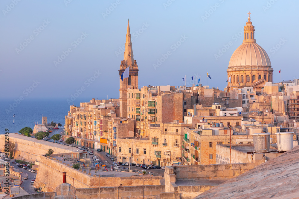 Obraz na płótnie View of Old town roofs, fortress, Our Lady of Mount Carmel church and St. Paul's Anglican Pro-Cathedral at sunset , Valletta, Capital city of Malta w salonie