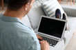 © Pixel-Shot - Young man with laptop chatting at home