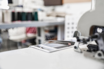 Modern sewing machine in tailor workshop, closeup